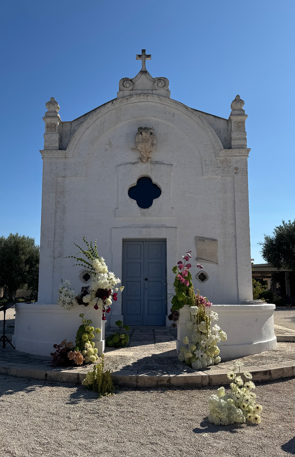view of the chapel with wedding floral arrangements in white and red colors.