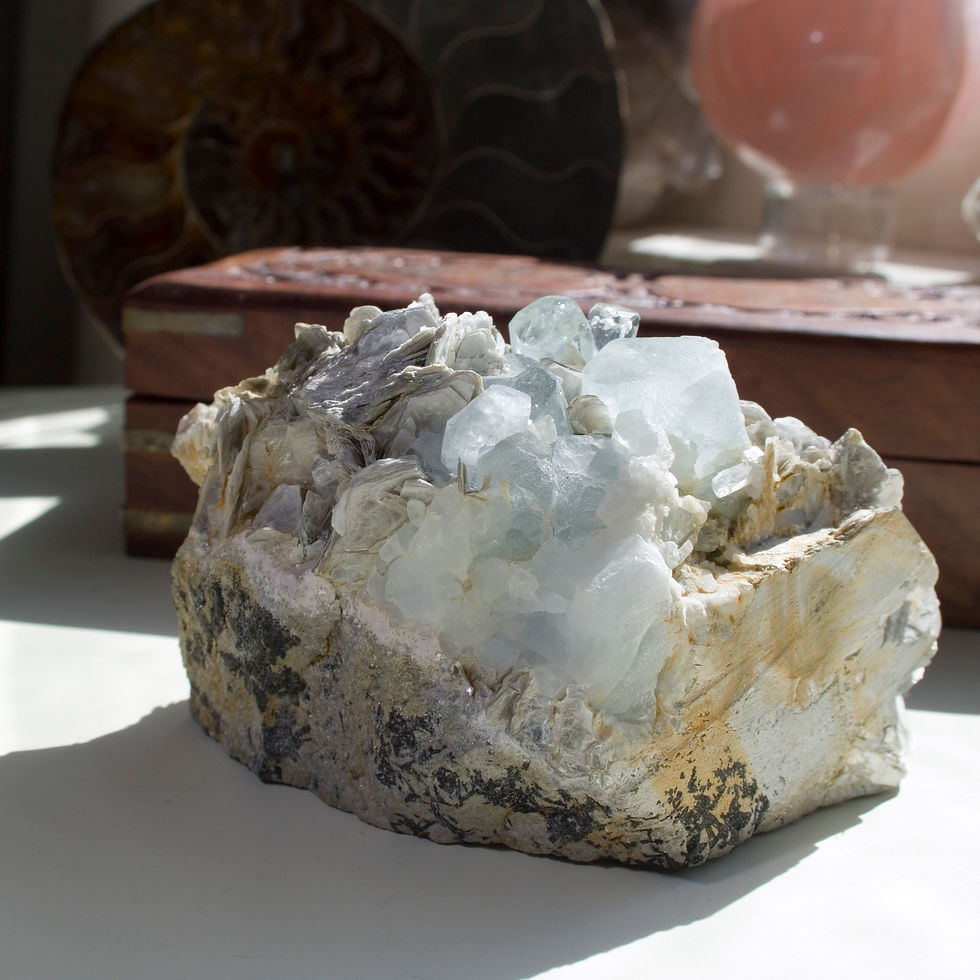 Thumbnail: A pair of terminated crystals of Quartz are adjacent to a set of gemmy, terminated Aquamarine crystals surrounded by blades o