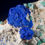 Thumbnail: Two central bright blue crystals of Azurite are offest with small crystals of Cerussite and green Malachite. Studio Mineralia