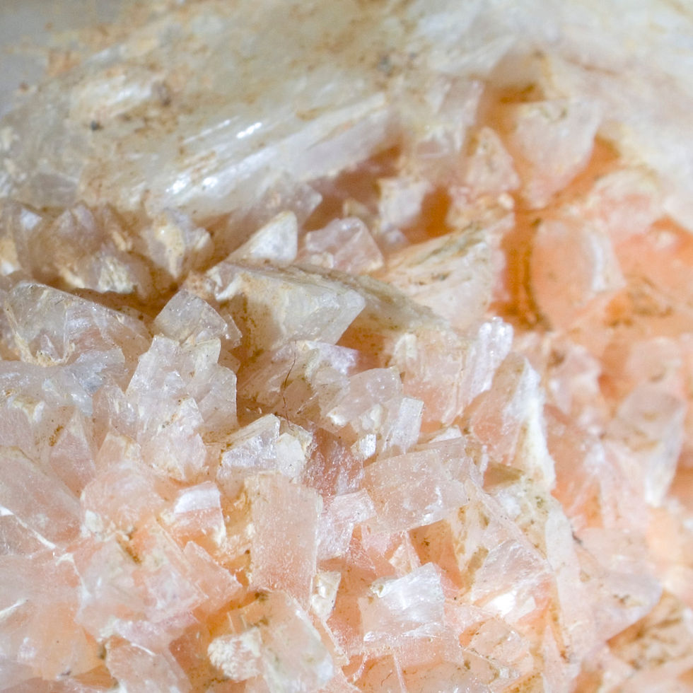 Two main bladed crystals of White Stilbite perch perfectly on a bed of hundreds of miniature crystals of Orange to Clear/Whit