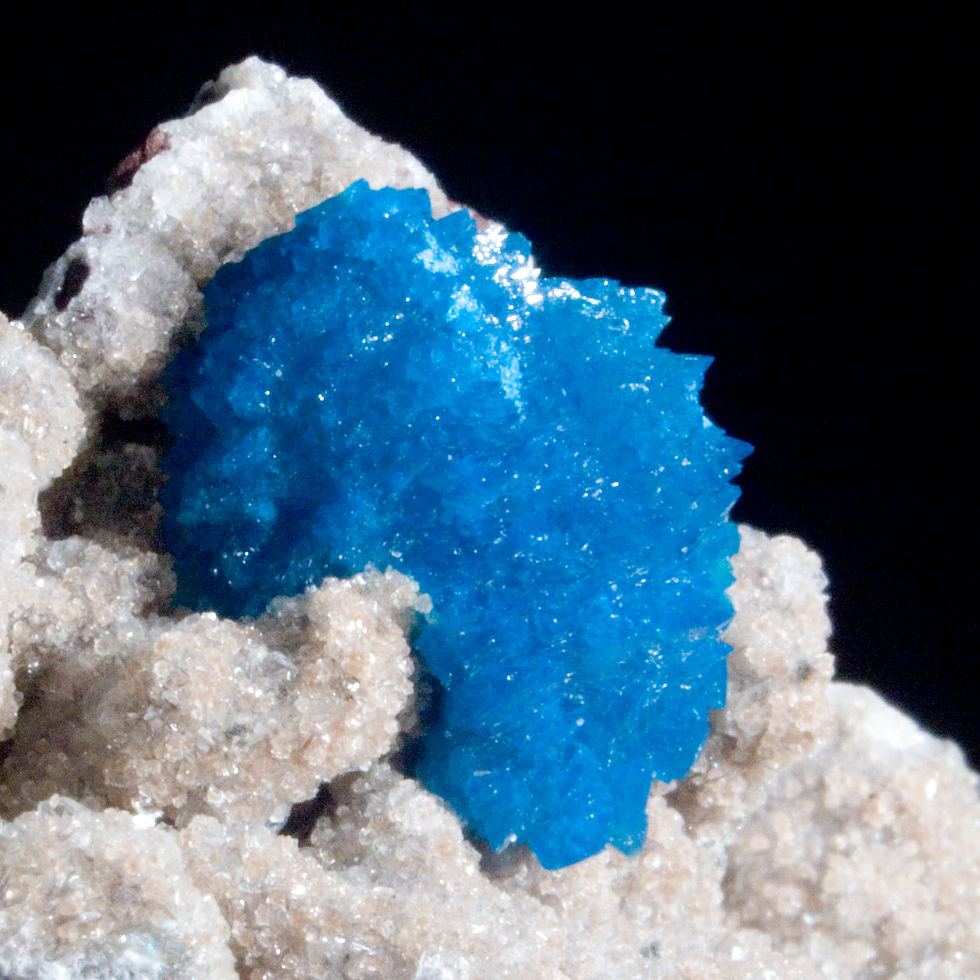 A complex matrix hosts a single large crystal of Cavansite. Crystals of sandy Heulandite cover the Basalt matrix. Presents in