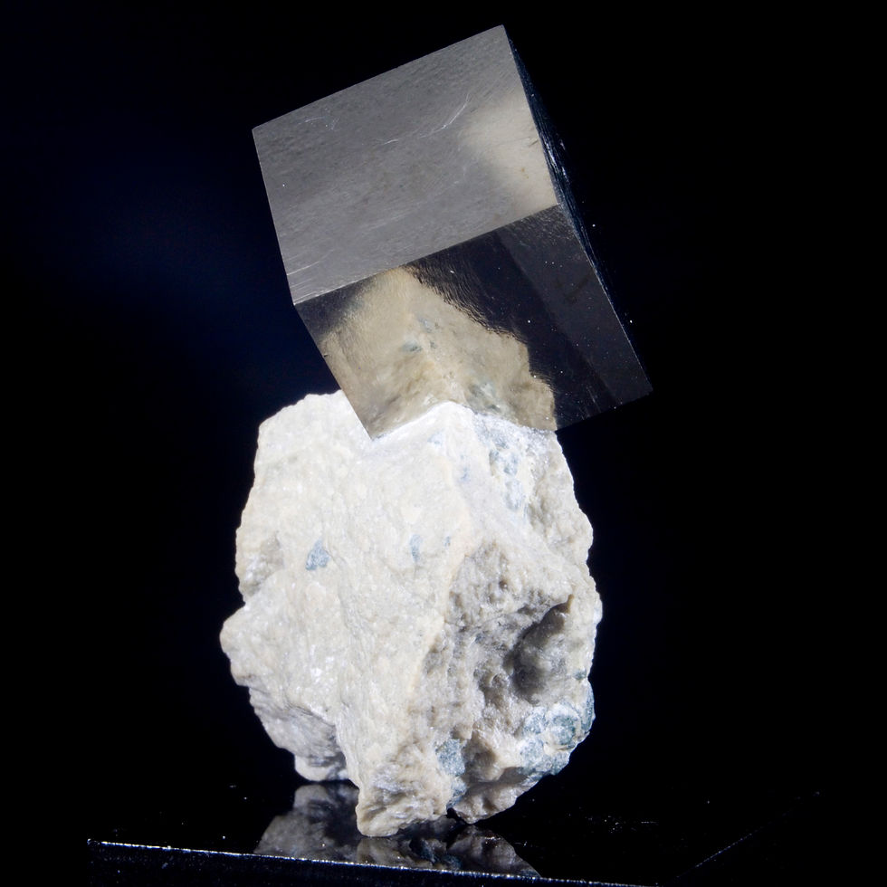 An exceptionally balanced matrix specimen, one .5" cubic crystal of Pyrite perches high above the matrix which contains a sma