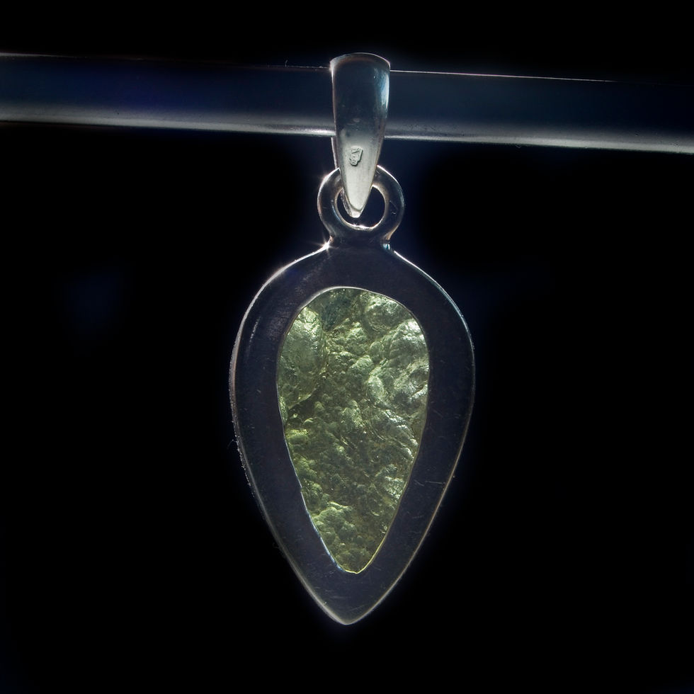 Thumbnail: This Moldavite pendent is artfully framed in .925 Silver (Sterling) ready to adorn your favorite chain.