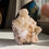 Thumbnail: A tall, confidently freestanding specimen featuring large crystals of Stilbite on a base of smaller crystals of Stilbite and