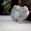Thumbnail: A 1.5 inch crystal of multi tiered etched, light green cubic Apophyllite provides a focal point on a matrix scattered with cr