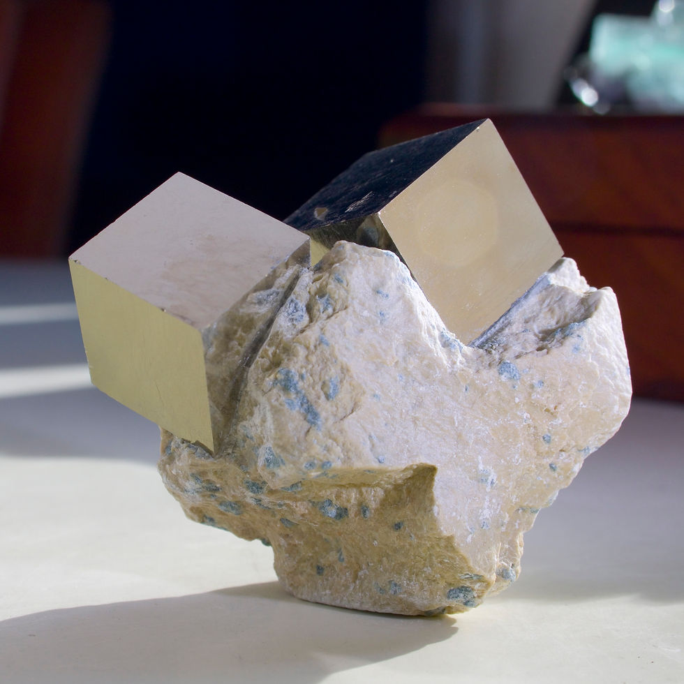 Thumbnail: Two perfectly balanced crystals of cubic Pyrite of two scales on the Marl matrix in which they grew. This form and quality of