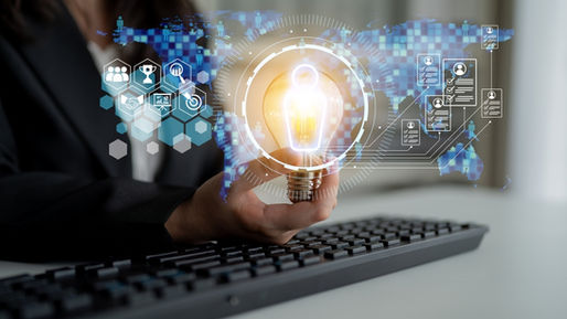 Business professional holding a glowing lightbulb symbolizing innovation and AI-driven workforce ideas, with digital icons for hiring, training, and analytics over a global map background.
