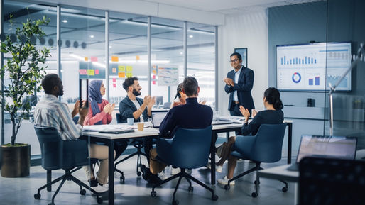 Business team collaborating in a modern office, discussing strategy and fostering autonomous decision-making.