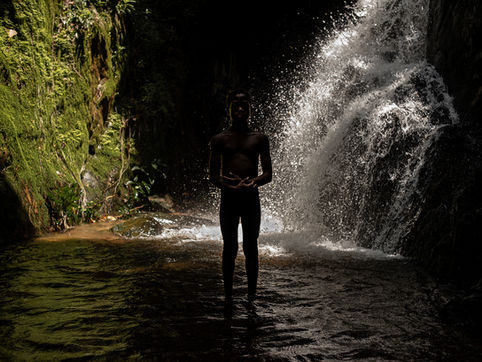 I was going to visit this sacred place, a waterfall located inside the forest, while a young man of about twelve years old came up and in silence went up with us throught the path into the deep of the forest. Arriving at the sacred waterfall, the young man went to the base of it, in the center of the pool and placed his hands in a mystical attitude, staring at me. Then silently, returned the path that led down into the forest and disappeared between the trees.