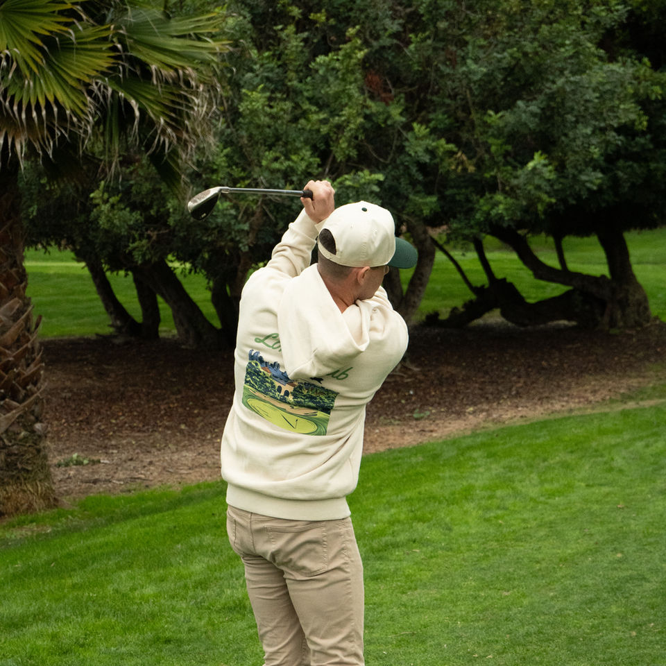 Decorative photo of a golfer swinging on the Loma Club course
