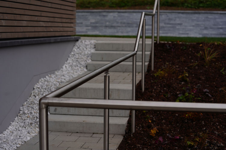 Gehweg mit Treppe und Chromstahl Handlauf