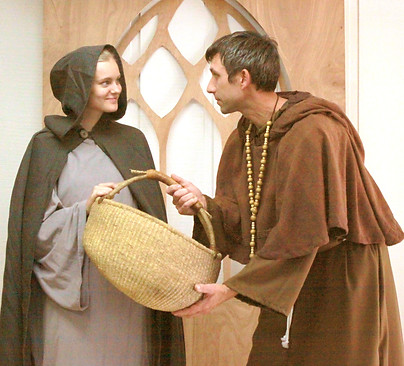 Katharina Von Bora (Ariel Strom) receives assistance from Martin Luther (Ryan Imel) in her