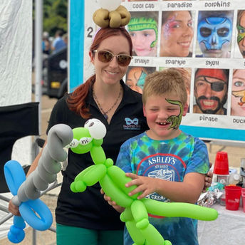Kid holding a dinosaur balloon animal for party in Branford CT