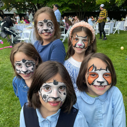 kids with animal face paintings, puppy dog and kitty cats