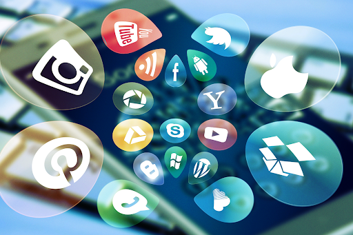 Multimedia logos and icons floating out of a cellphone
