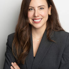 A person in a suit smiling with arms crossed during Amsterdam corporate event headshot photoshoot.