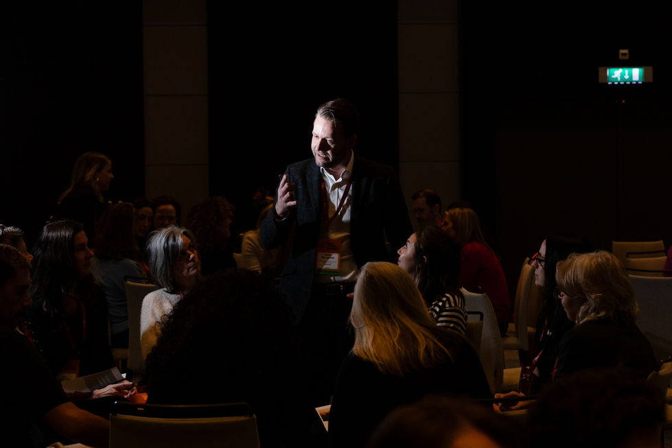 Engaged speaker sharing insights at a business leadership event.