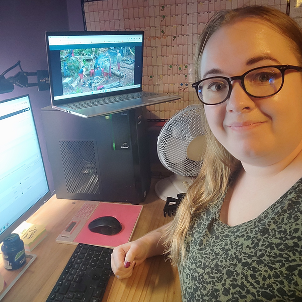 Tania at her desk with her computer and laptop, watch I'm A Celeb