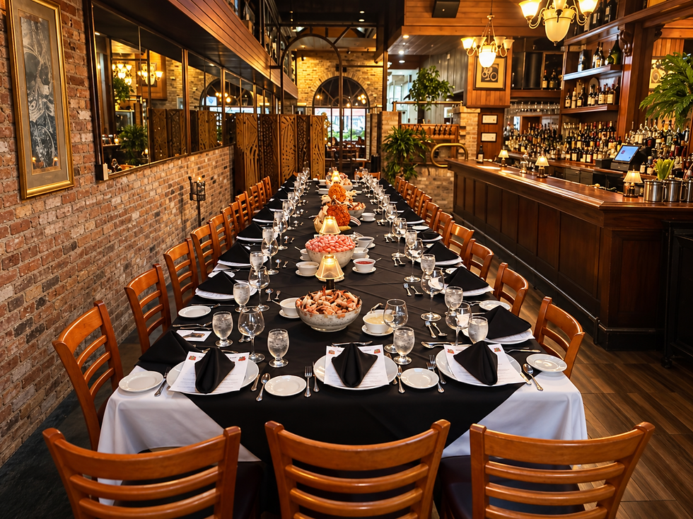 Elegant private dining room with a long set table, black napkins, wine glasses, warm wood bar, and brick walls in cozy amber light
