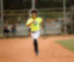 High angle view of a coach demonstrating proper throwing technique to a small group of young players