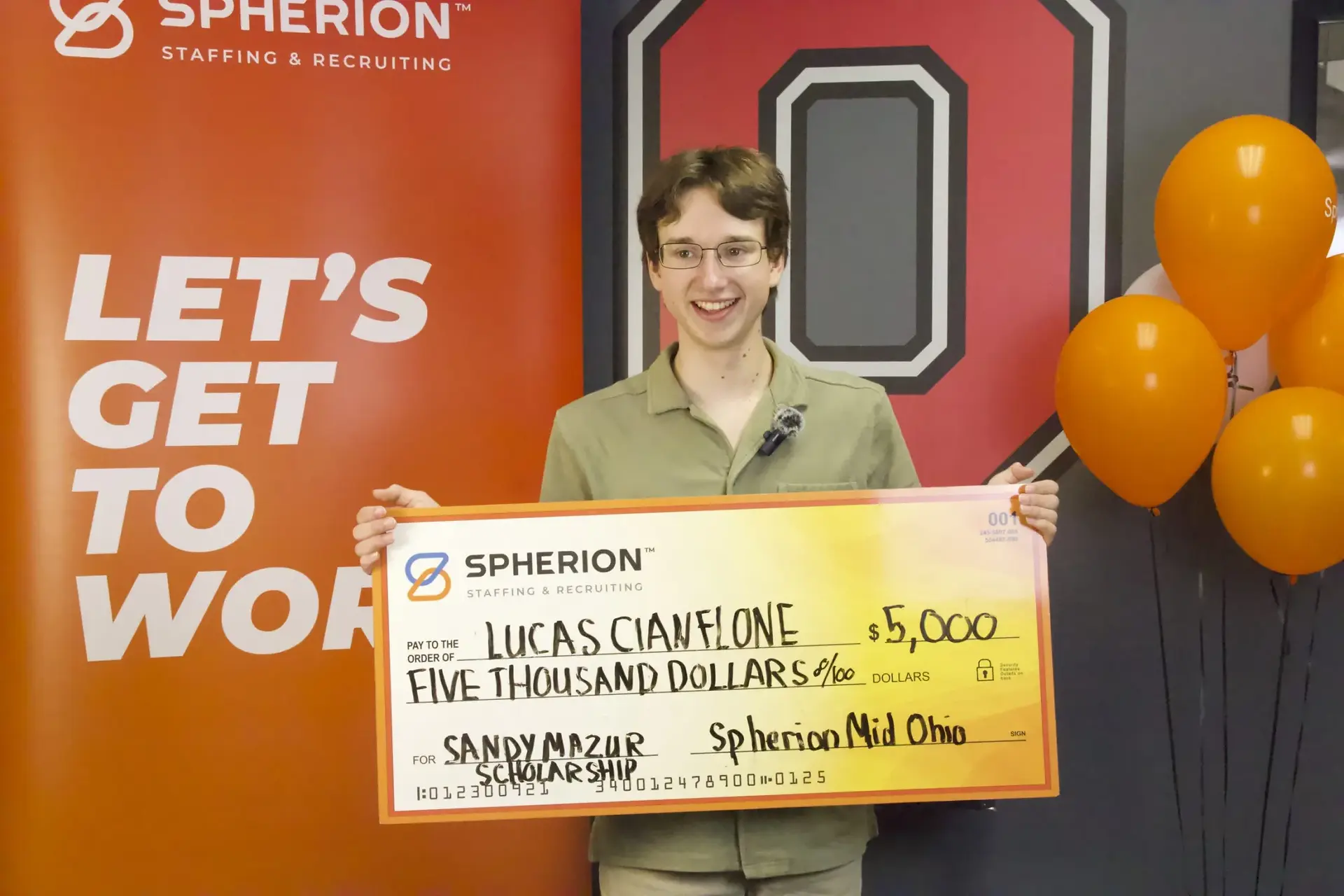 Lucas Cianflone holding a $5,000 check from Spherion, Sandy Mazur scholarship program.