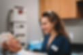 Doctor smiling and talking to an elderly male patient.
