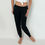 Thumbnail: model wearing Fleece Jogger in black with elastic waistband and drawstring tie