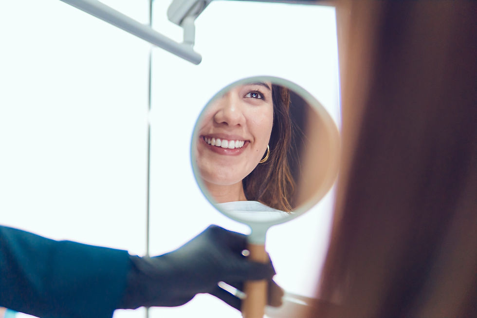 Beautiful woman smiling when looking at herself through a mirror