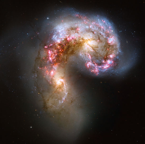 Two interacting galaxies with bright star-forming regions and tidal tail formation