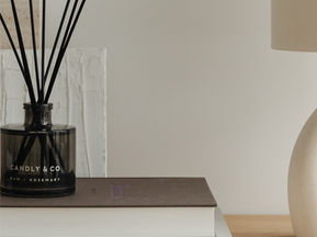A fragrance diffuser on a stack of books.