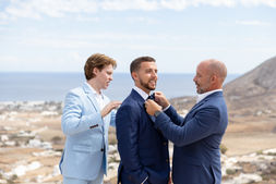 Groom getting ready at Le Ciel Santorini Greece destination wedding groom preparation Denver wedding photography