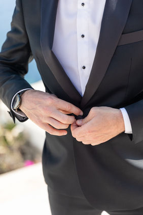 Groom getting ready at Love Cave Suites Santorini Greece elopement groom preparation Tom