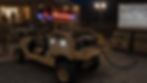 Custom tactical all-wheel vehicle with built-in power systems supplying off-grid electricity to a mobile field operations center and tactical display at night.
