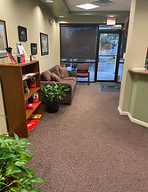 A commercial floor with visible dirt, debris, and a yellow 'caution' sign, representing the need for professional floor clean