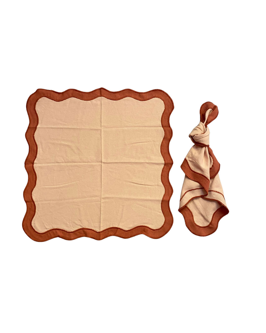 Tan / terracotta scalloped napkins for hire on the Gold Coast, knotted and open as placemat