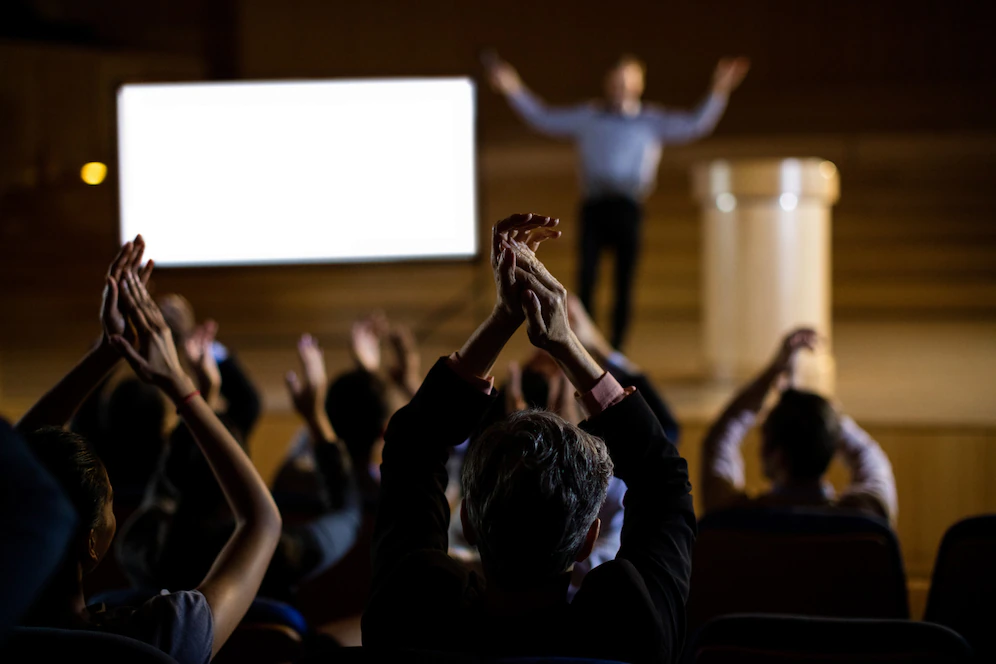 audience-applauding-speaker-after-conference-presentation_107420-63802.webp