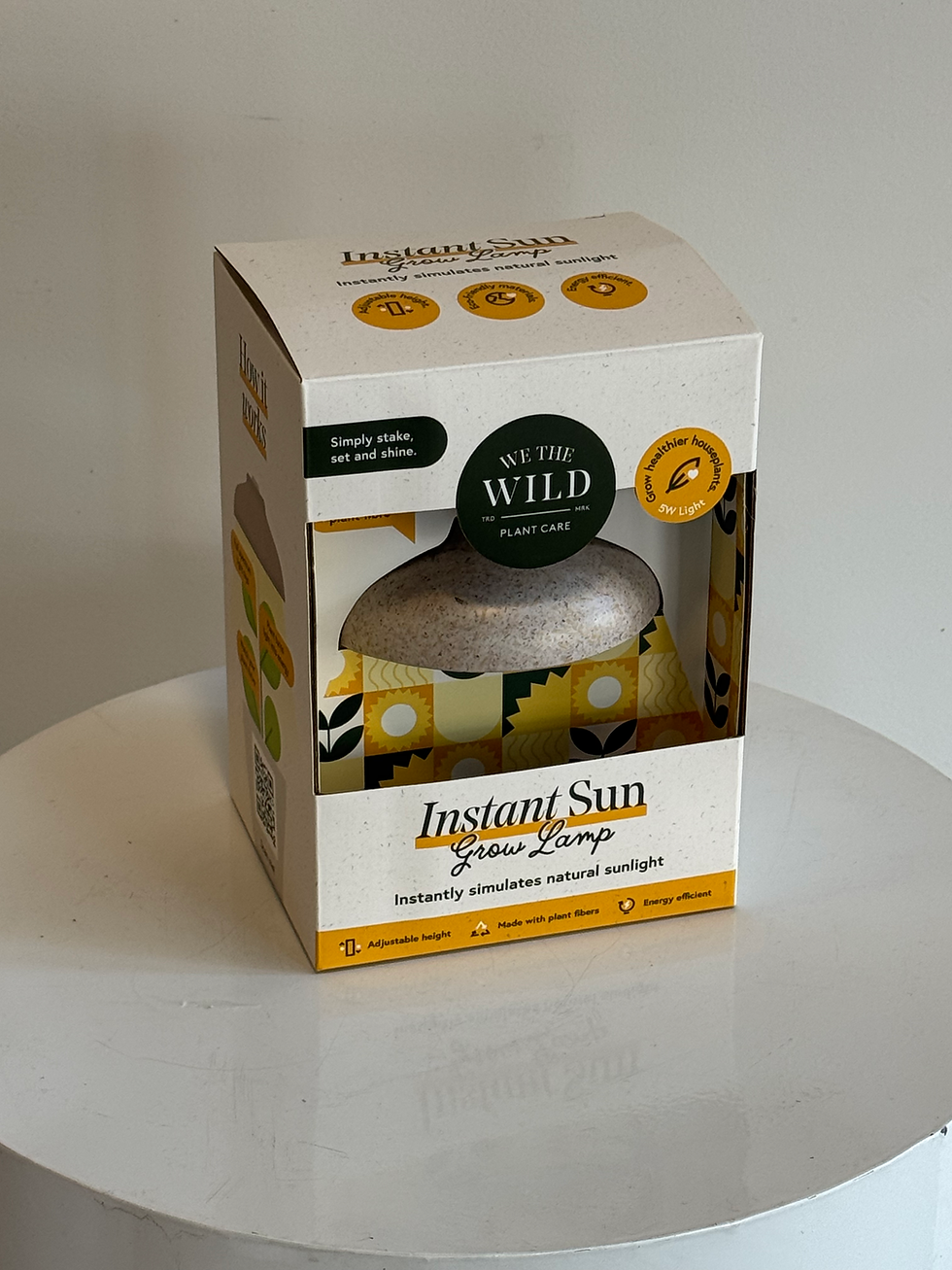 Instant Sun Grow Lamp by We The Wild in its original packaging, displaying the compact grow light design.