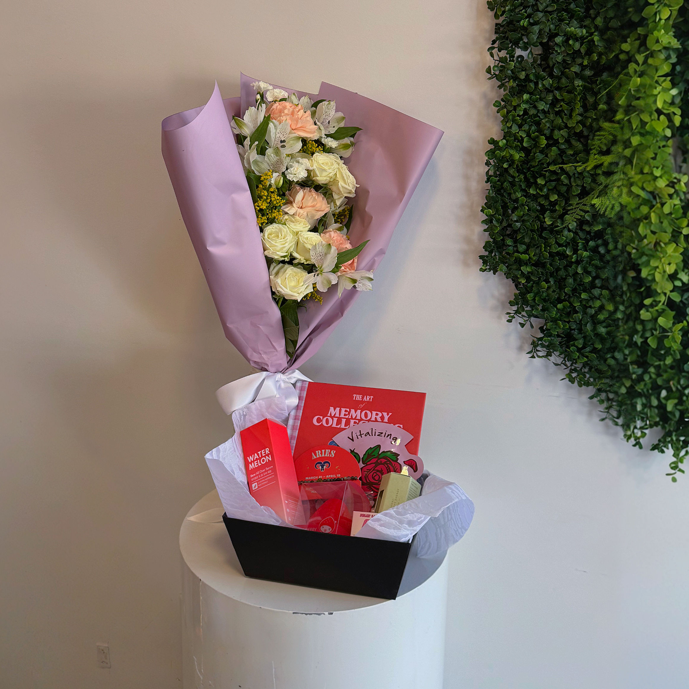 The Blooming Lover gift basket featuring fresh flowers, a keepsake journal, watermelon serum, bloodstone zodiac bracelet, whi