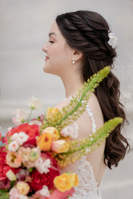 Bride side profile with red and yellow summer wedding bouquet at The Madison Club, a Madison Wisconsin Wedding Venue