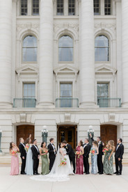 Large wedding party celebrating at the Wisconsin State Capitol just two blocks from at The Madison Club, a Madison Wisconsin Wedding Venue