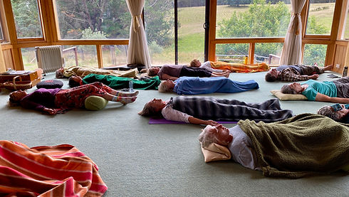People lying on ground meditating