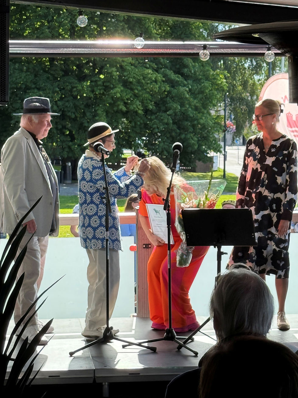 Johanna Oras saa kaulaansa Mustan Pässin kunnianosoituksen.