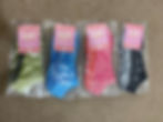 4 pairs of Flow Peppy Grip socks: Green tiger stripes, blue tiger stripes, pink cheetah pattern and black.