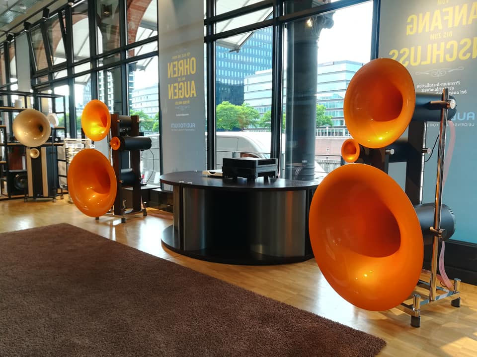 Large orange speakers displayed in showroom