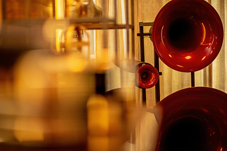 Three red horns displayed against a wall, Sabo Audio projects and installations.