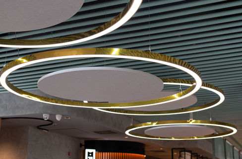 BACH-installed circular acoustic panels at Scusa Mi Italiano to reduce reverberation in the café environment.