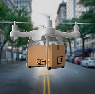 A drone holding a package above a city street