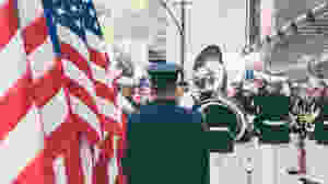 <img src="band.jpg" alt="marching band performing with american flag">