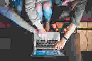 <img src="planning.jpg" alt="teenager planning college application with parents on macbook computer on a coffee table">