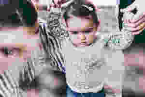 <img src="baby.jpg" alt="parents teaching their baby girl how to walk">